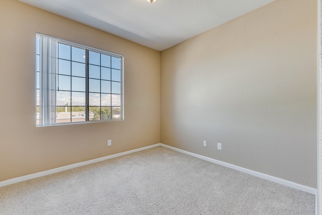 an empty living room with a large window