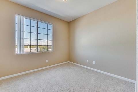 an empty living room with a large window