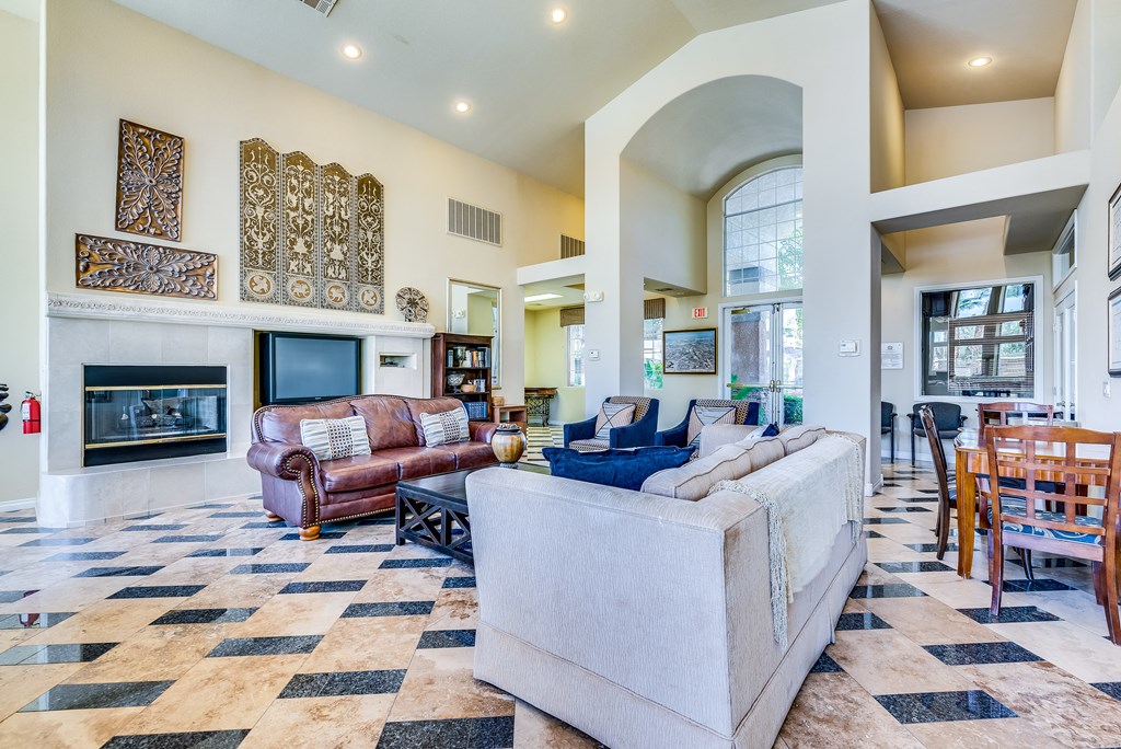 a living room with couches and chairs and a fireplace