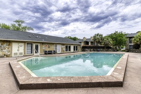 A small pool in front of a building.