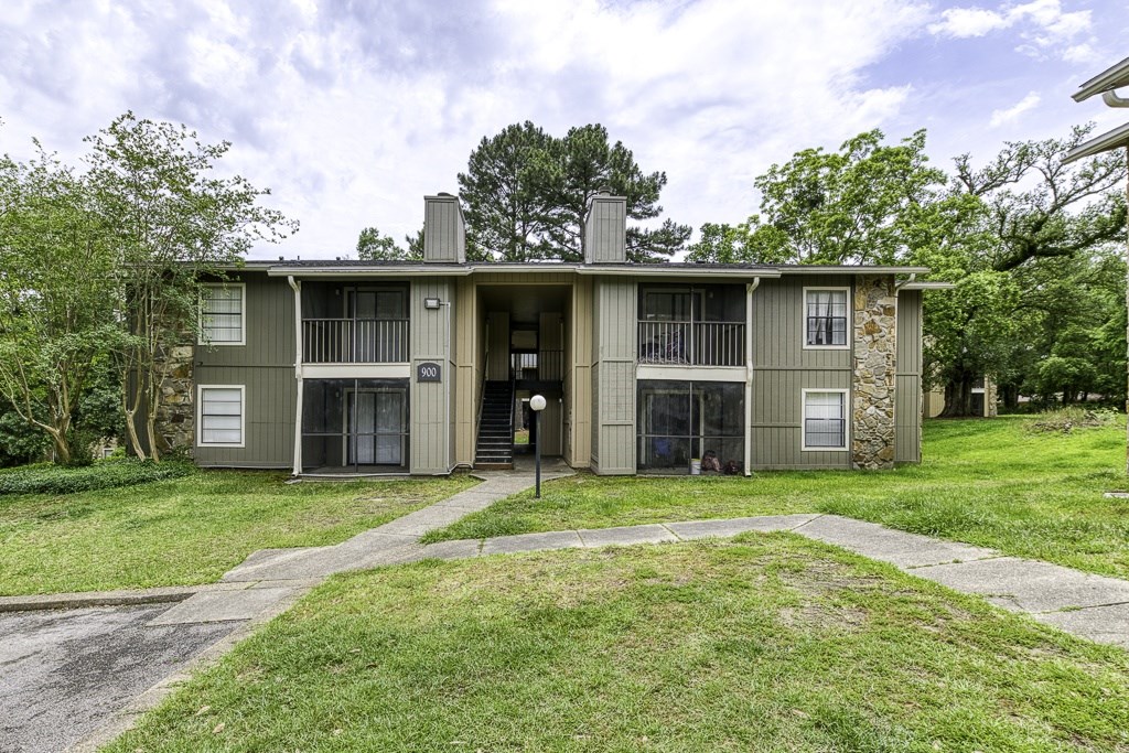 A two-story apartment building with a garage door on the first floor.