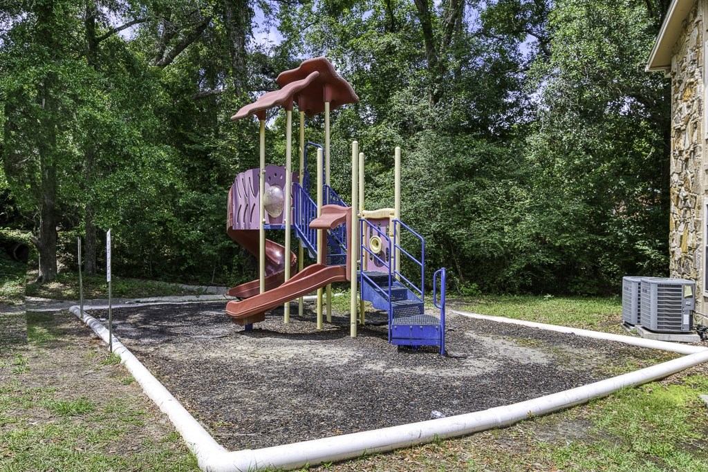 A playground with a slide and a swing set.