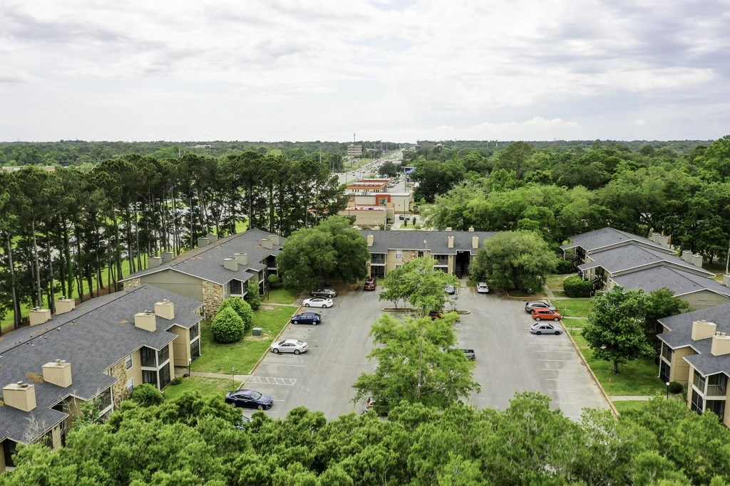 A view of a residential area with houses and cars.