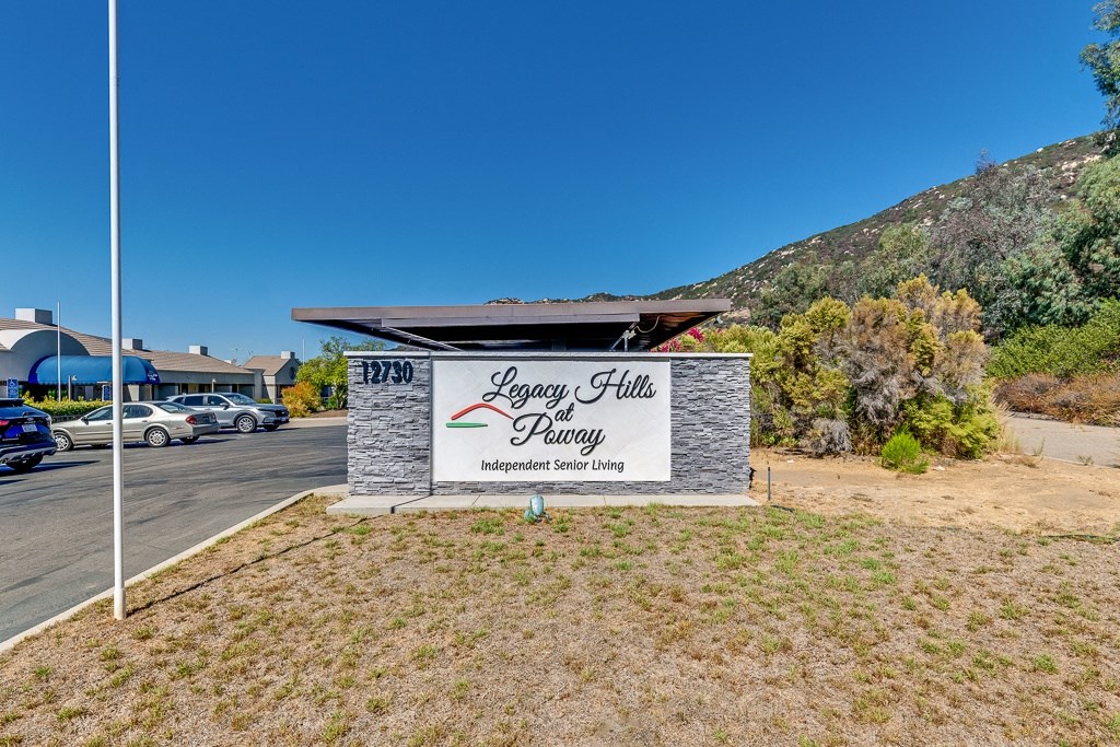 A sign for Legacy Hill Senior Living is displayed in front of a building.