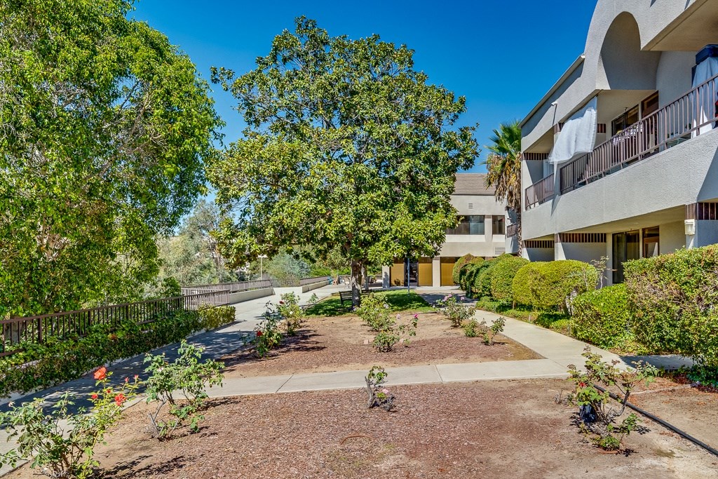 A sunny day at a residential complex with a well-maintained garden.