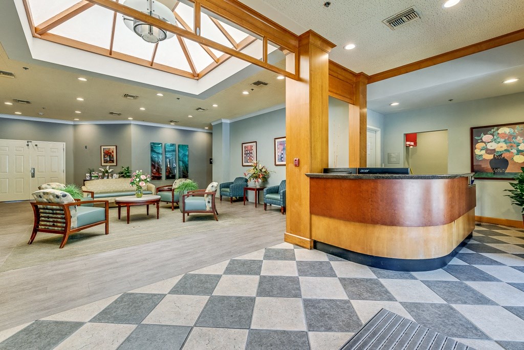 A reception area with a checkered floor and a wooden counter.