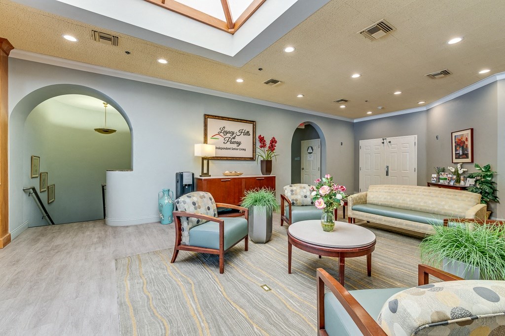 A living room with a sofa, chairs, and a coffee table.