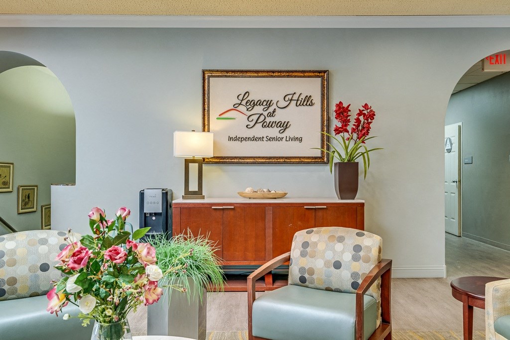 A reception area with a sign that says Legacy Hills Petway Independent Senior Living.