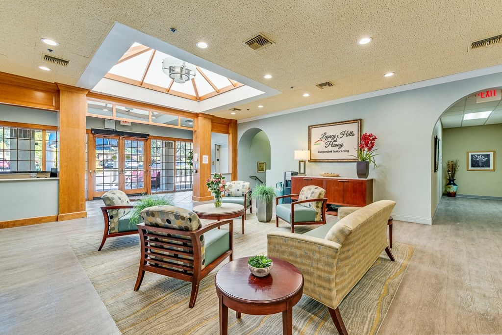 A living room with a couch, chairs, and a coffee table.