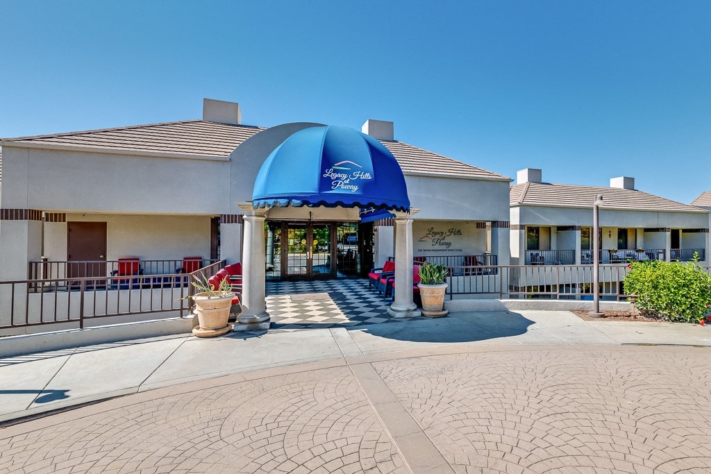A blue and white striped awning is over the entrance to a building.