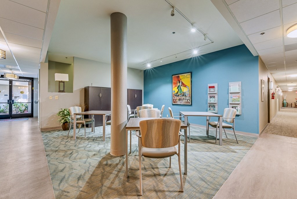 A conference room with a long table and chairs.