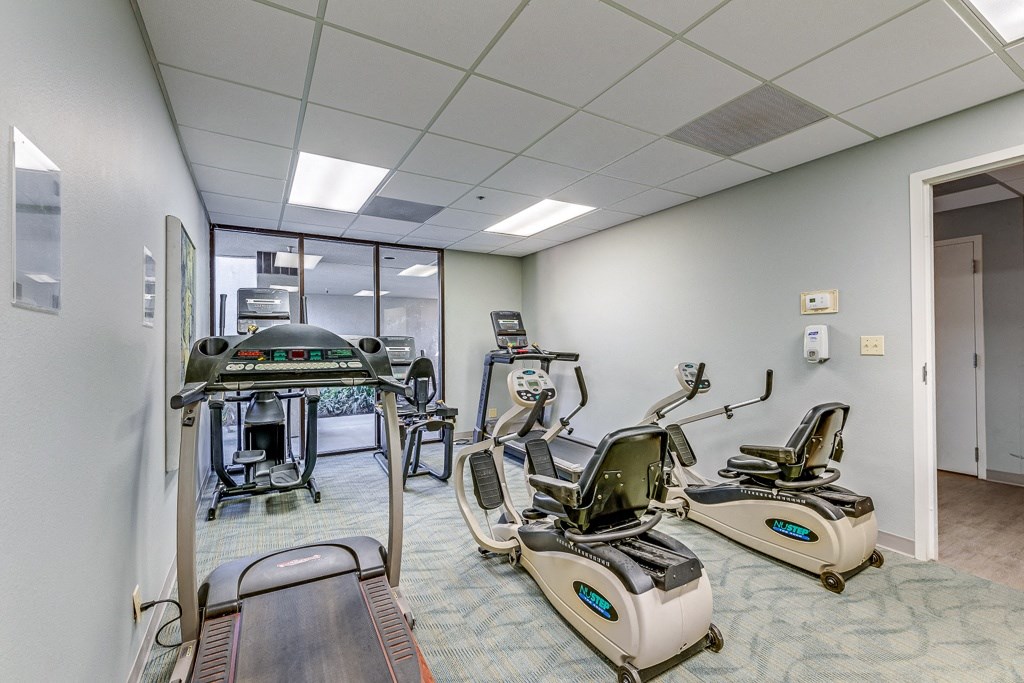 A room with exercise equipment and a treadmill.