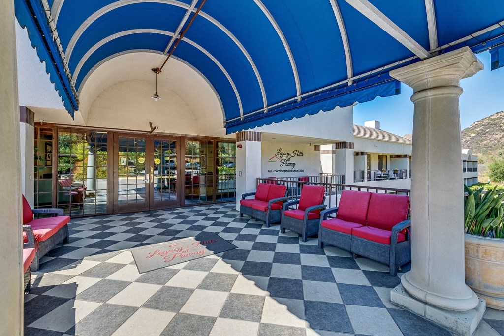 A checkered floor with a sign that says "Designs by Point" is under a blue and white striped awning.