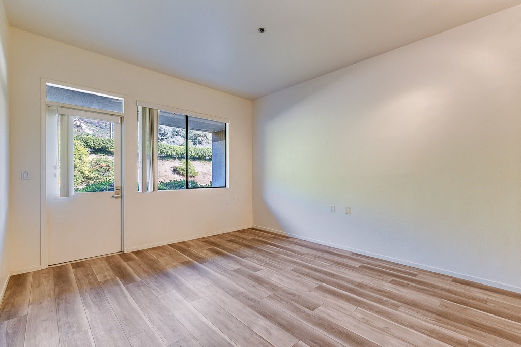 A room with a wooden floor and white walls.