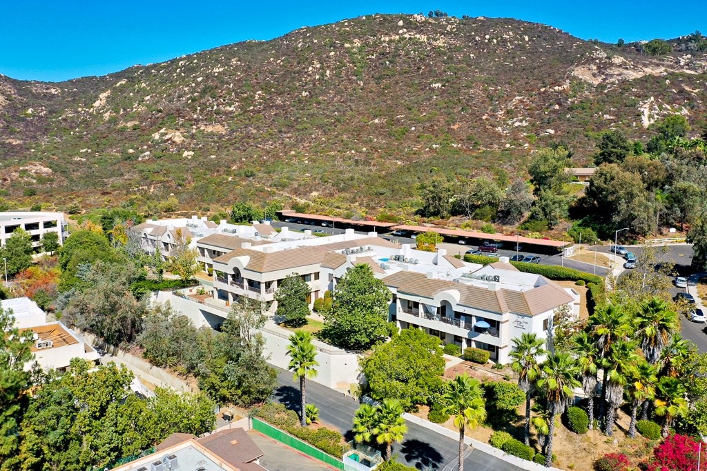 A mountainous area with apartment buildings in the foreground.