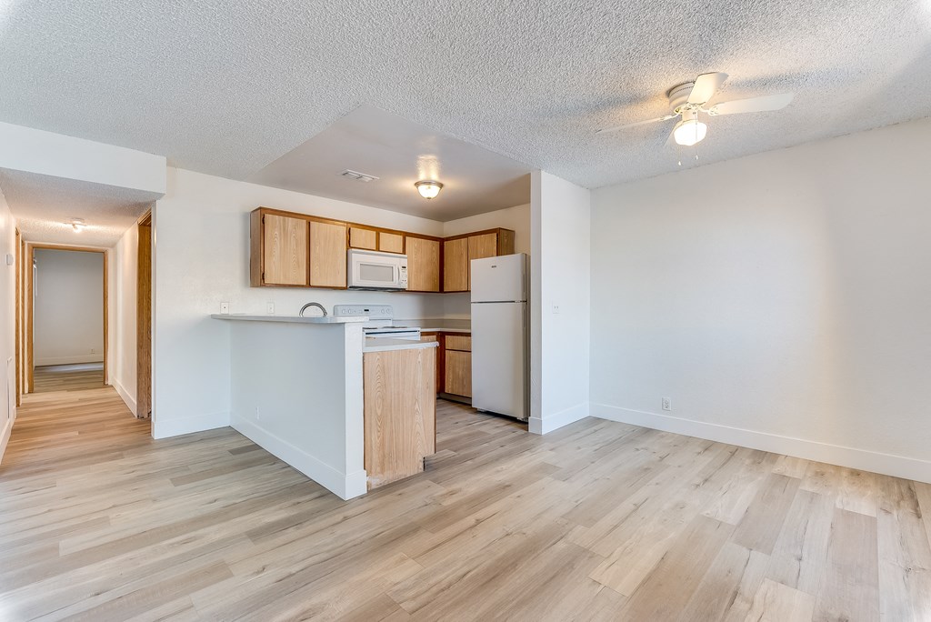 a kitchen and living room with hardwood floors and white walls at Pacific Harbors Sunrise Apartments, Las Vegas, NV, 89142