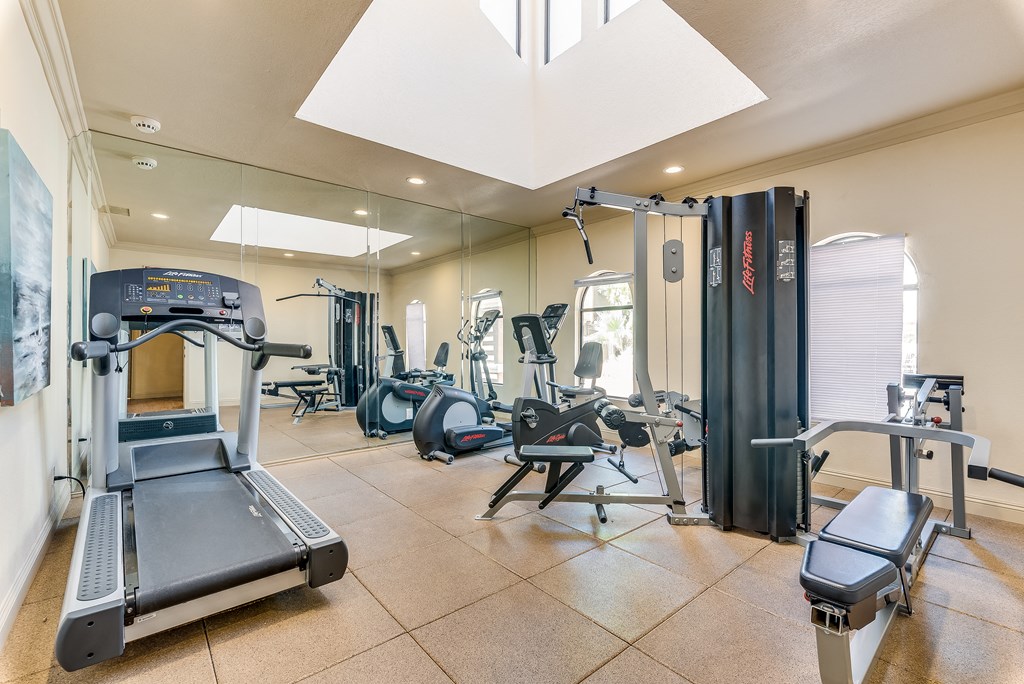 a gym with treadmills and other exercise equipment at Pacific Harbors Sunrise Apartments, Las Vegas, NV