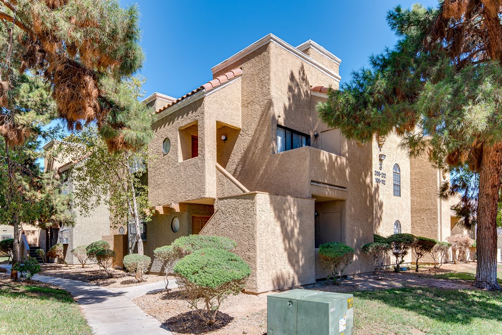 a building with a staircase and trees in front of it at Pacific Harbors Sunrise Apartments, Nevada