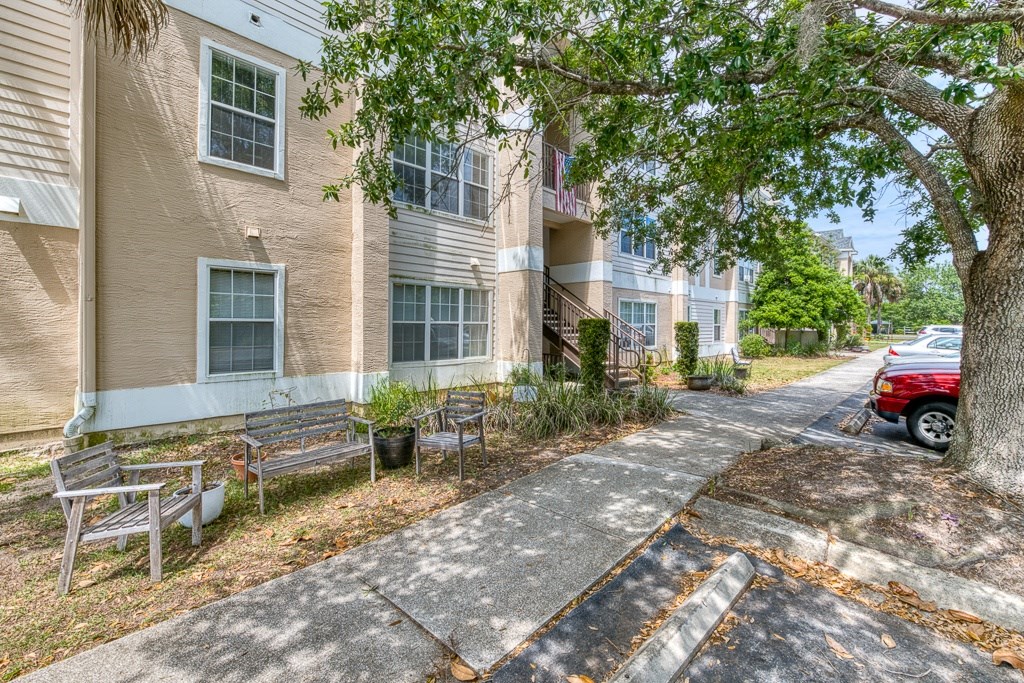 A red car is parked on the side of a road.