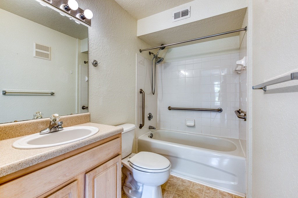 A white toilet sits next to a sink in a bathroom.