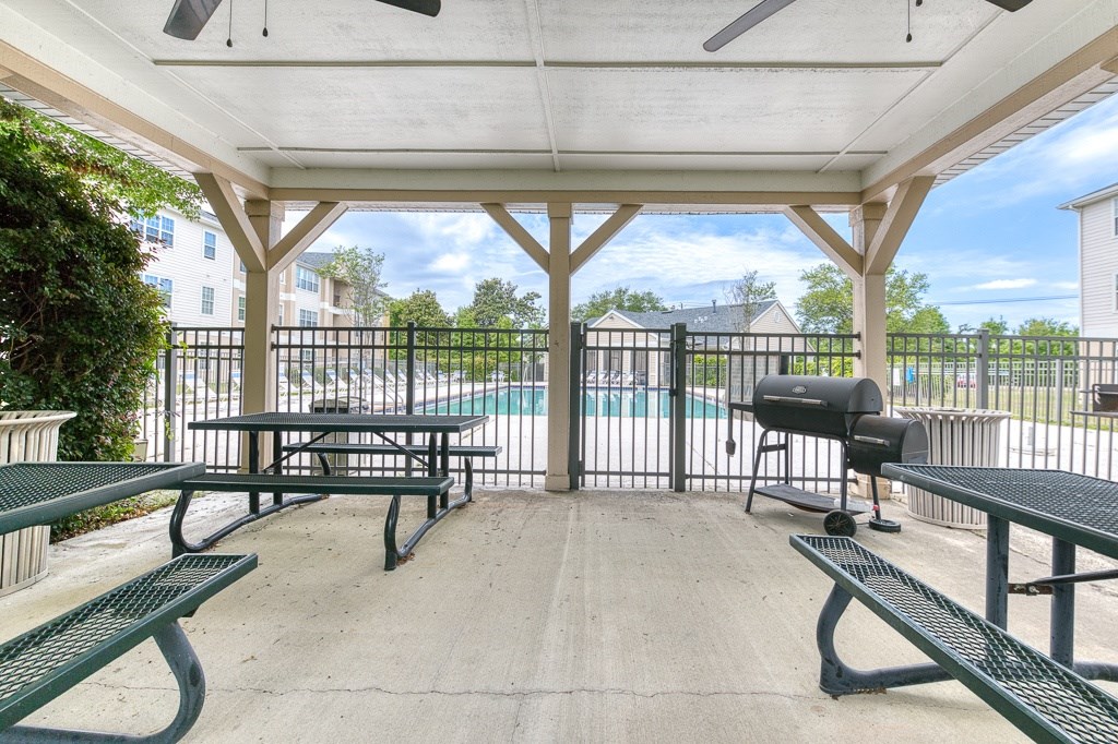 A covered picnic area with tables and benches.