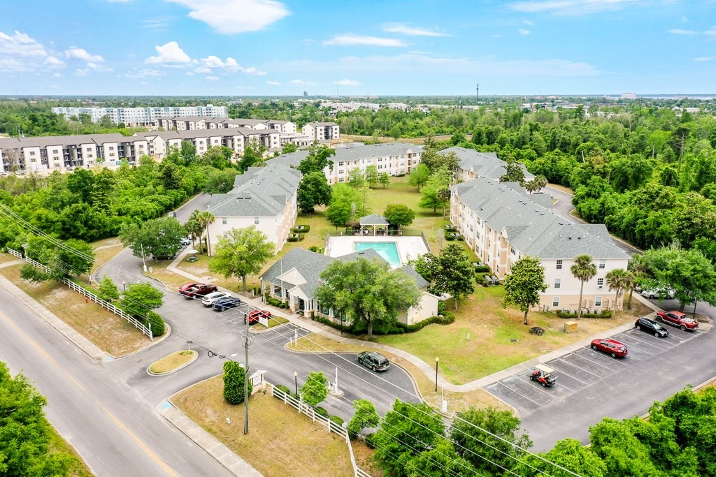 A bird's eye view of a residential area with houses and cars.