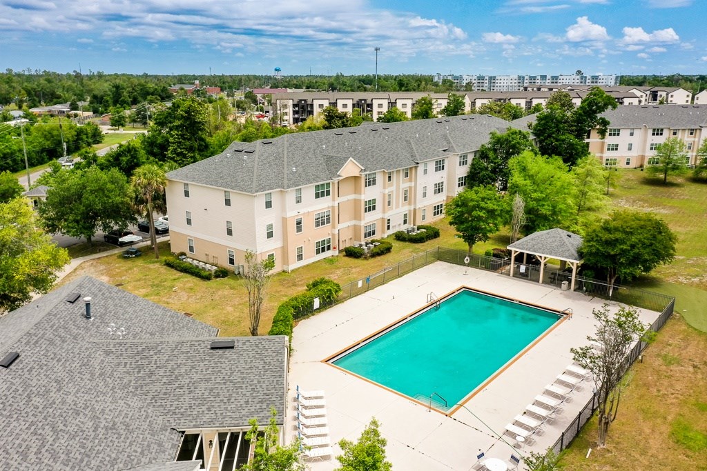 A large building with a pool in front.