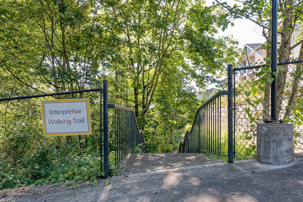 a gate with a sign that reads interpretive walking trail