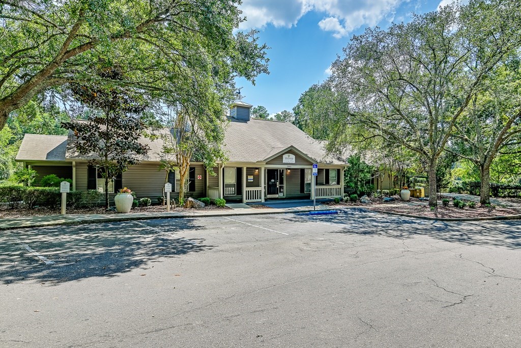 A house with a driveway and trees in front.