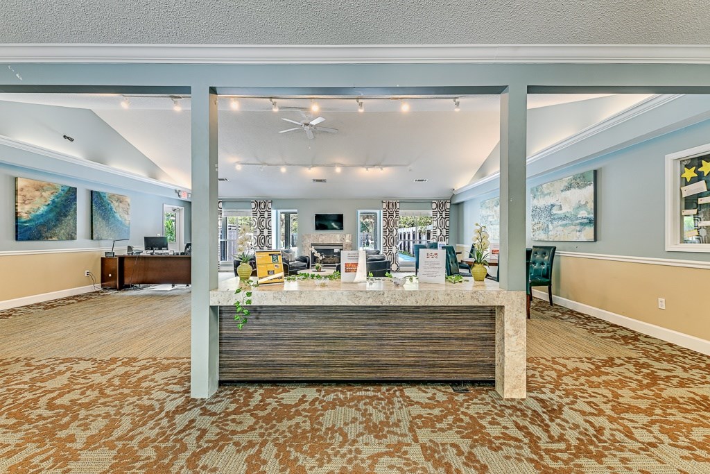 A reception area with a wooden bench and a carpeted floor.