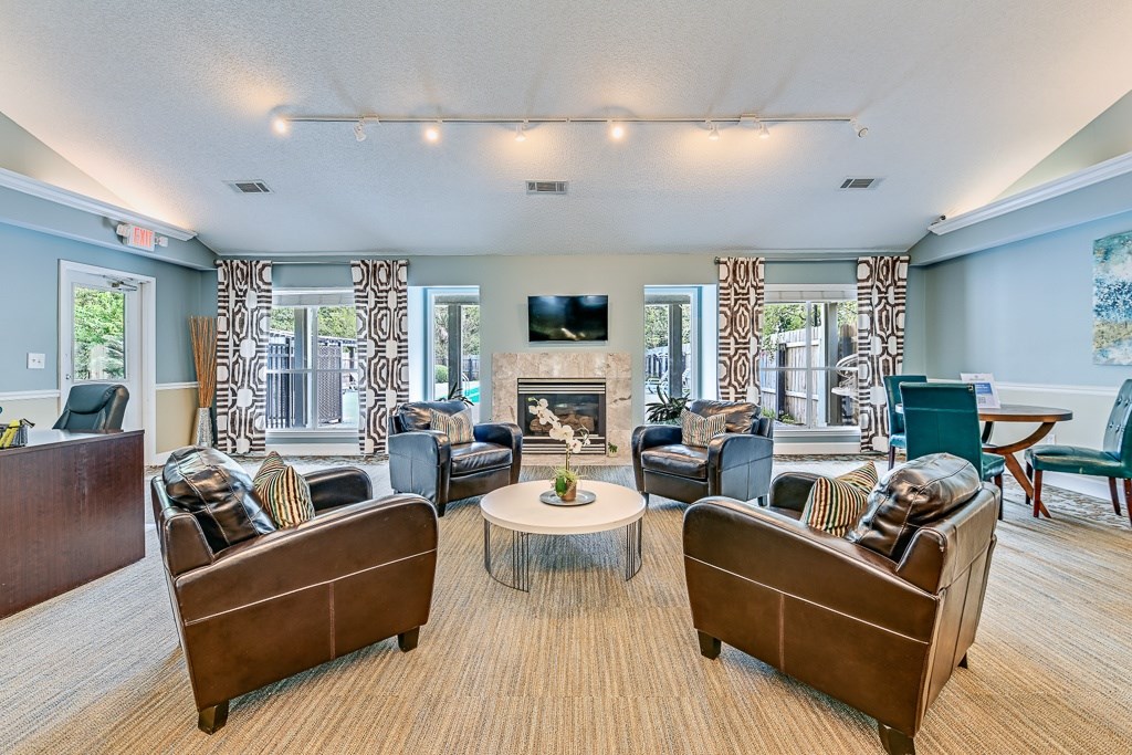 A living room with a fireplace and a television.