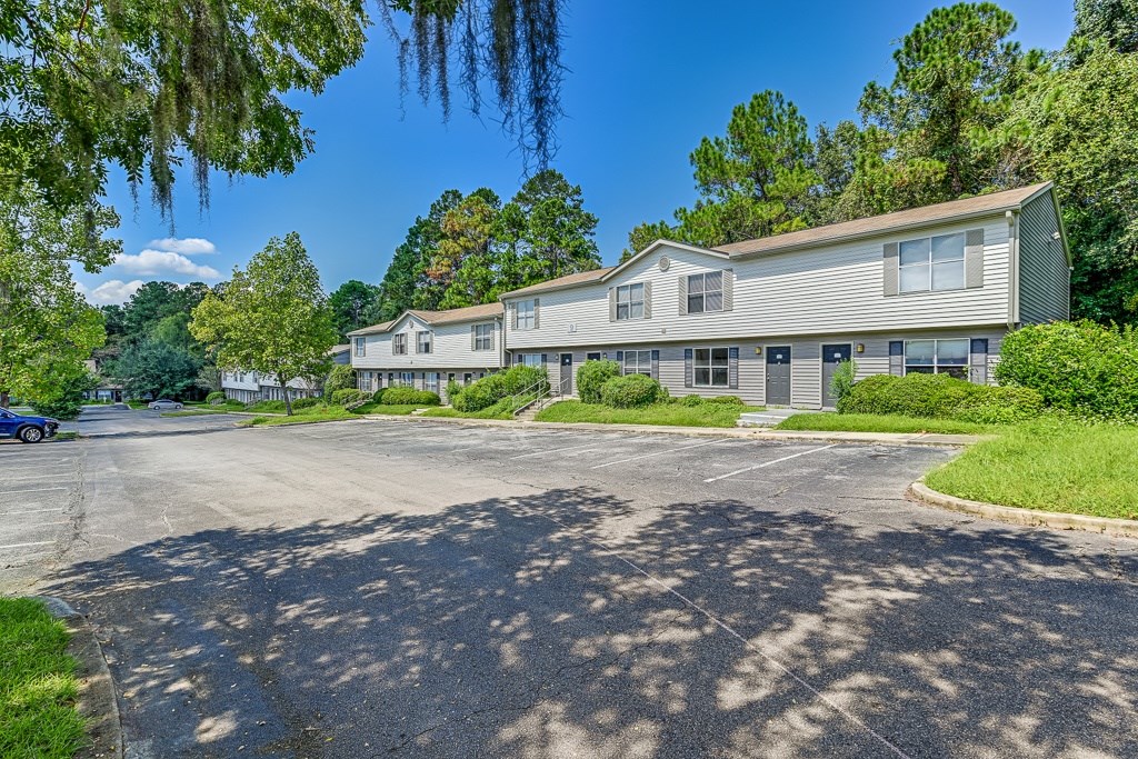 A large building with a parking lot in front of it.