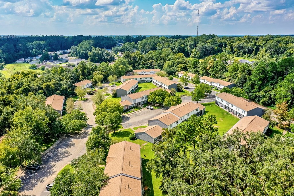 A bird's eye view of a residential area with houses and trees.