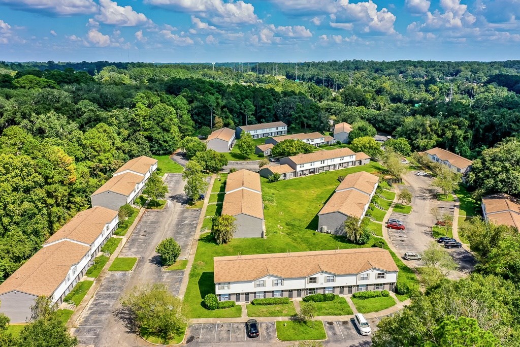 A bird's eye view of a residential area with houses and cars.