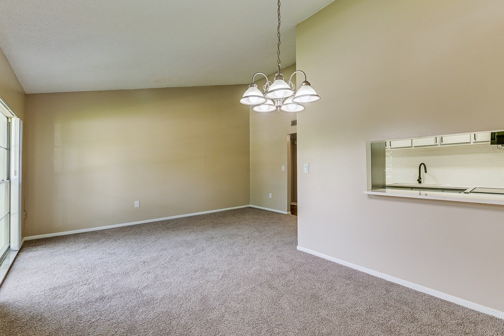 A room with a carpeted floor and a mirror on the wall.