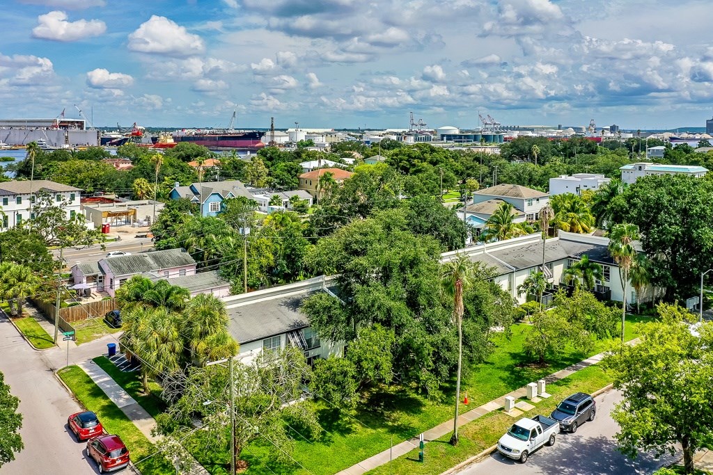 A view of a residential area with houses, trees, and cars.