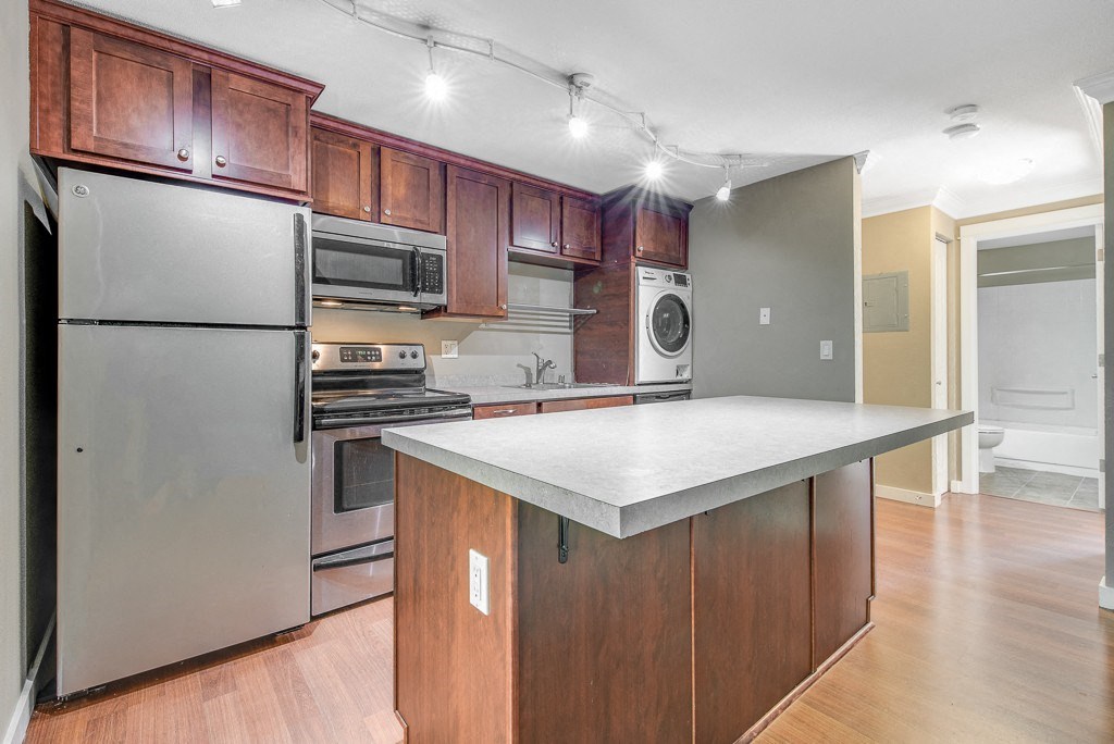Kitchen Island and Kitchen at Whispering Brook Apartments, Washington