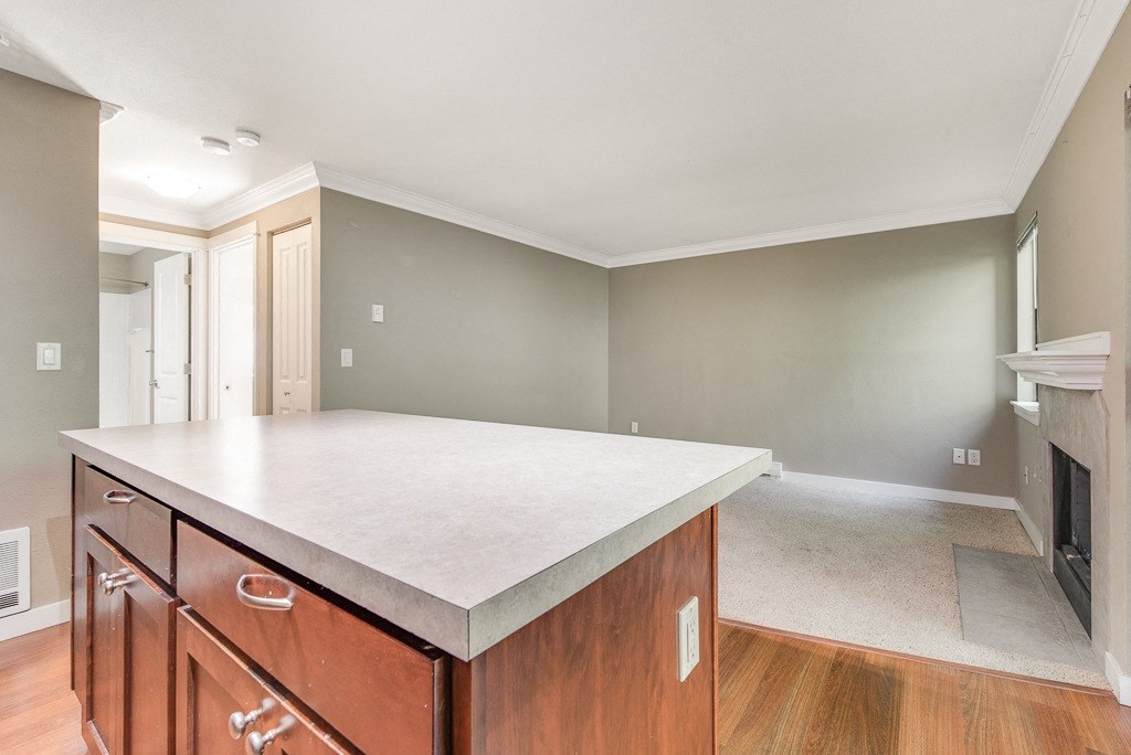 Kitchen Island Facing Living Room at Whispering Brook Apartments, Des Moines