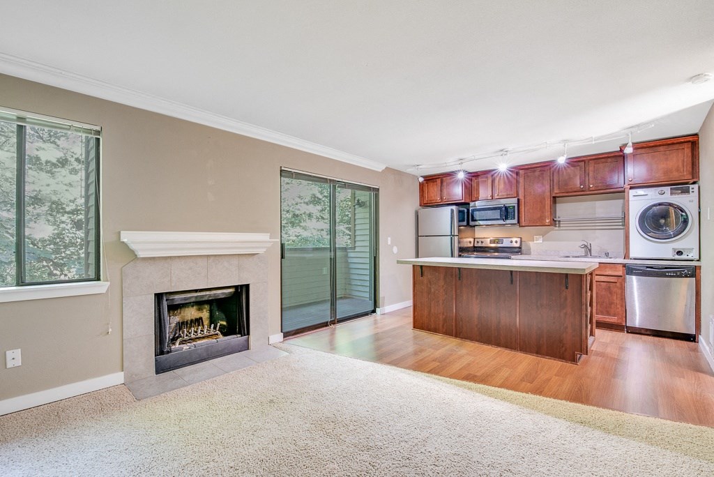 Living Room with Fireplace at Whispering Brook Apartments, Des Moines,98198