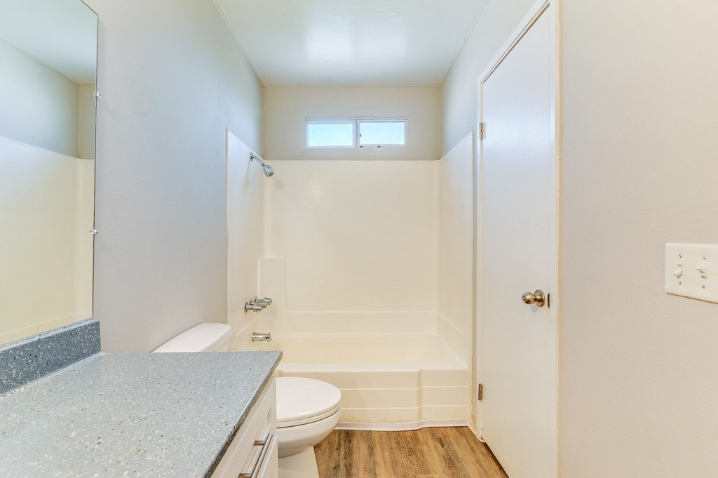 A small bathroom with a toilet, sink, and bathtub.