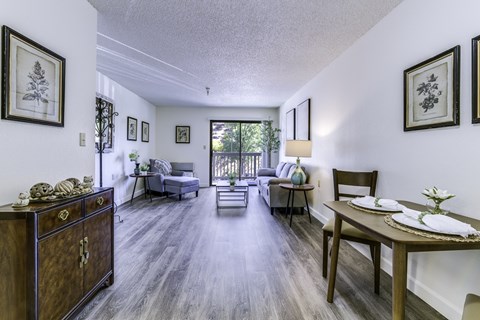 A living room with a grey couch and a wooden cabinet.