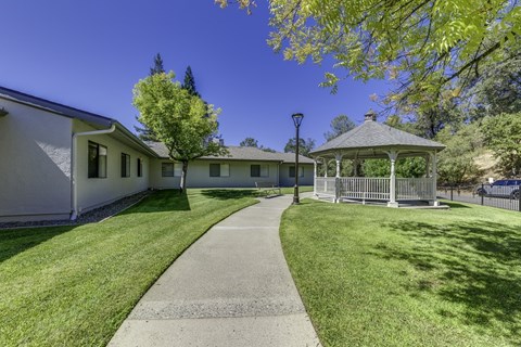 A white building with a gazebo in front of it.