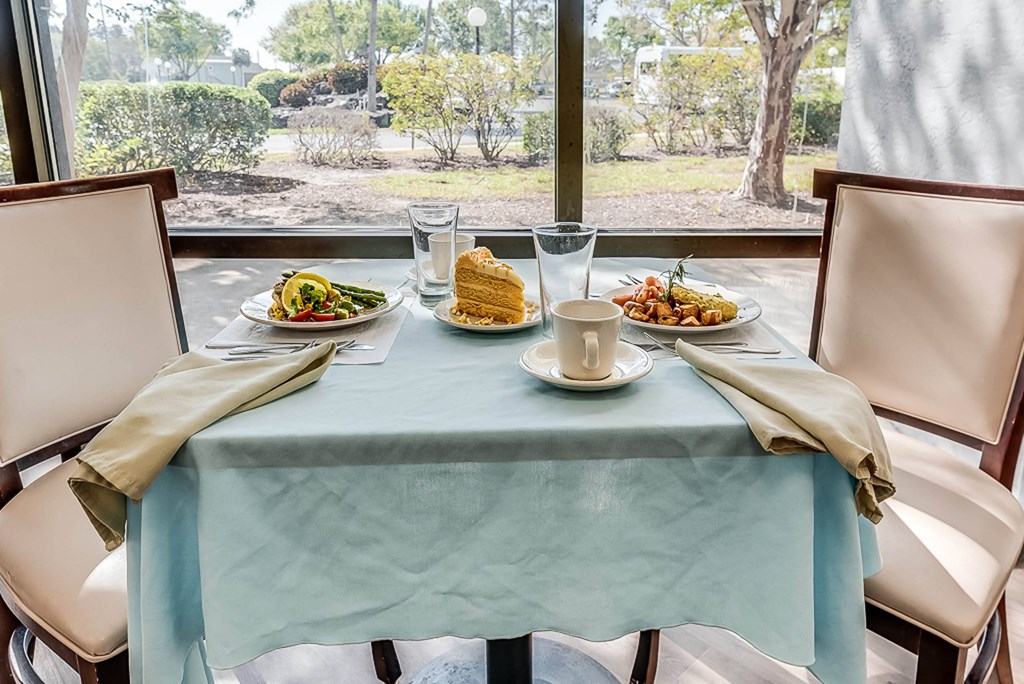 a table with a blue table cloth and plates of food on it