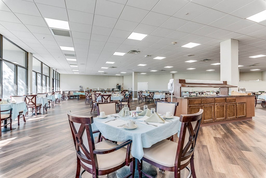 a large dining room with tables and chairs