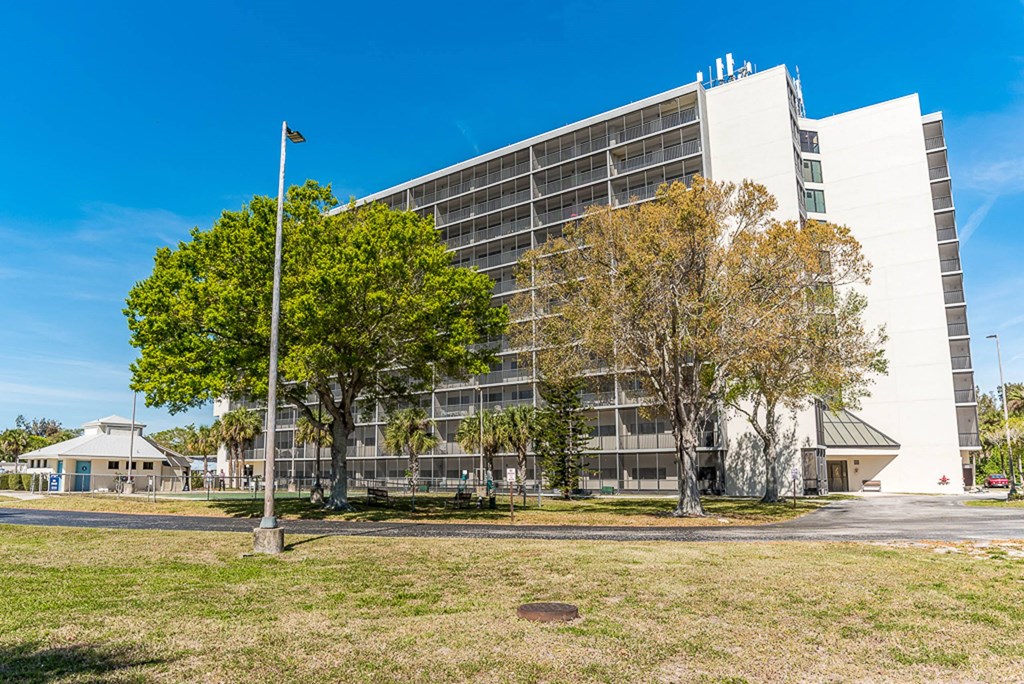 a large white building with a flagpole in front of it