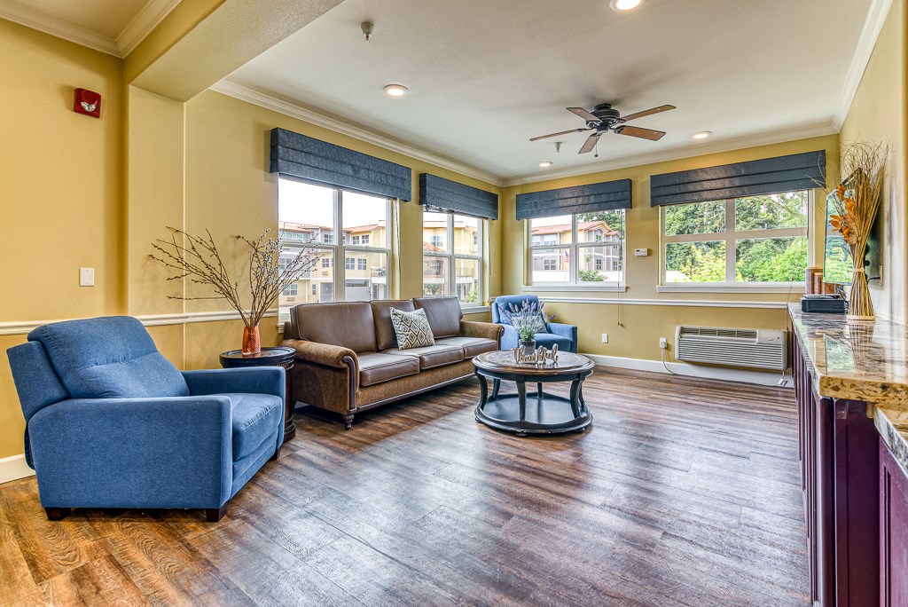bright and open common area with chairs and couch