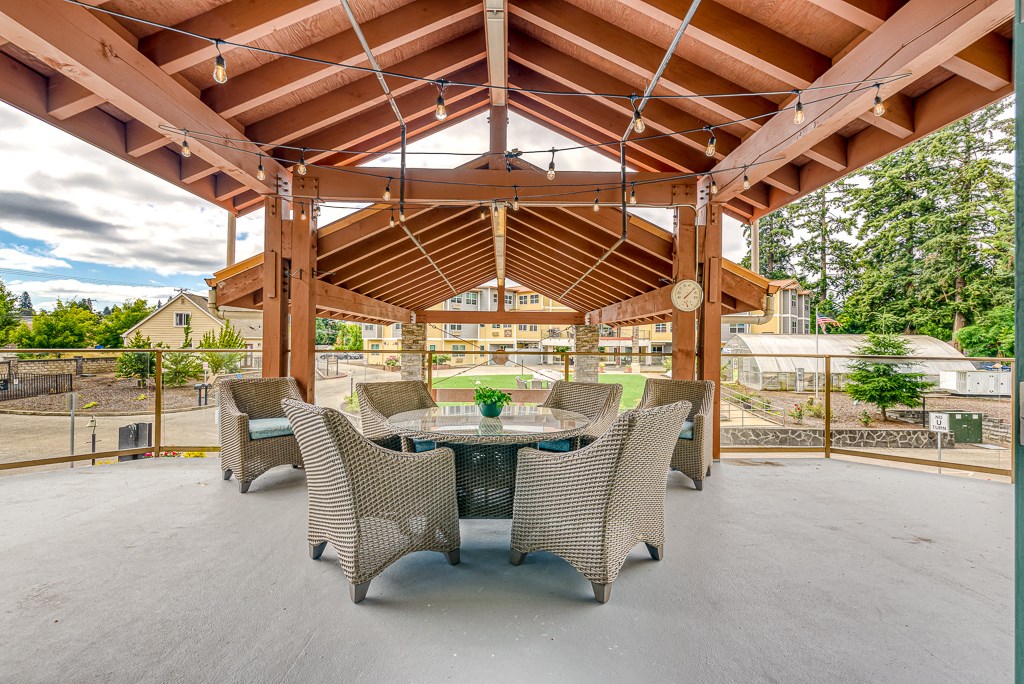 covered patio with table and chairs overlooking courtyard