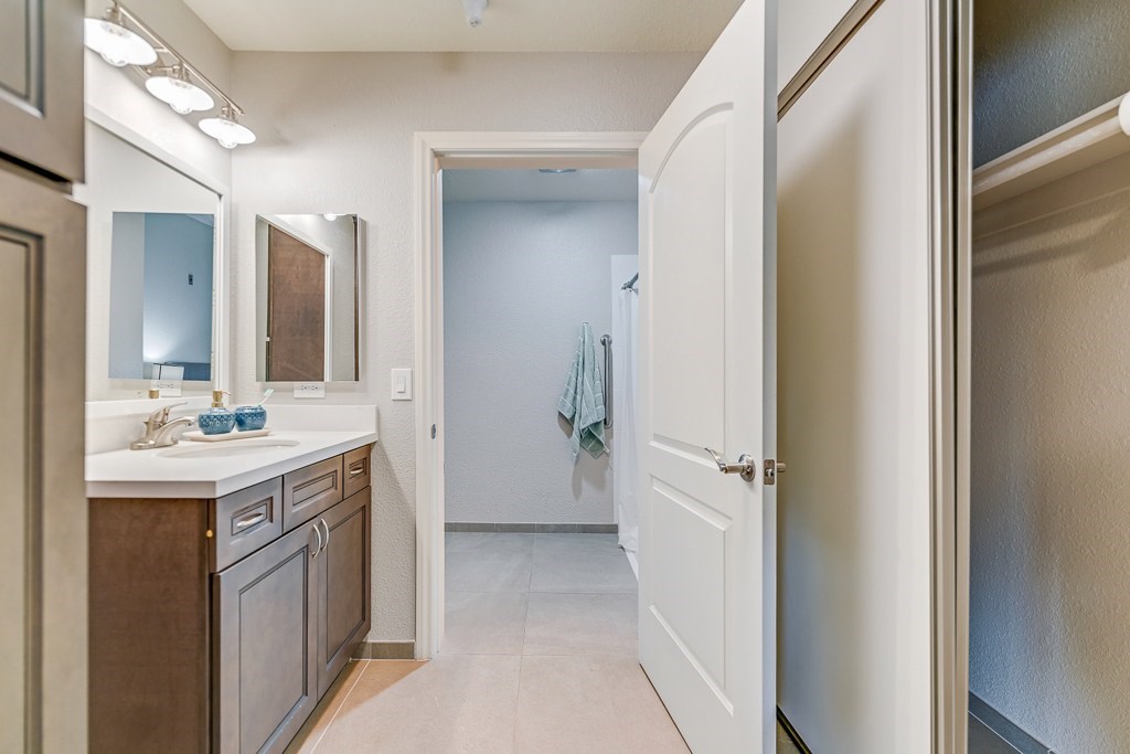A kitchen with a white door leading to a hallway.