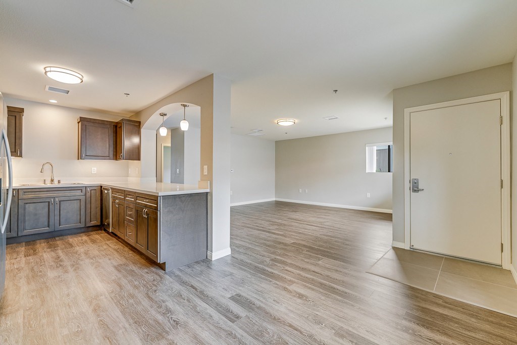 A spacious kitchen with wooden floors and a large island.