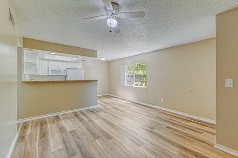 A room with a ceiling fan and wooden flooring. at Green Oaks Apartments, Tampa, FL, 33616